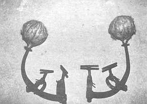 Fig. I The metallic device. Observe the ball of cotton and tar to be lighted and the screws to be tightened on the horns.